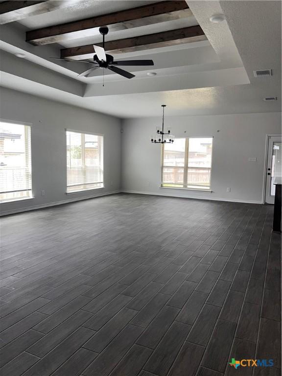 806 Dred Roger Cir, Killeen, TX 76542 - empty room with ceiling fan, beamed ceiling, a chandelier, a tray ceiling, and dark wood-style flooring