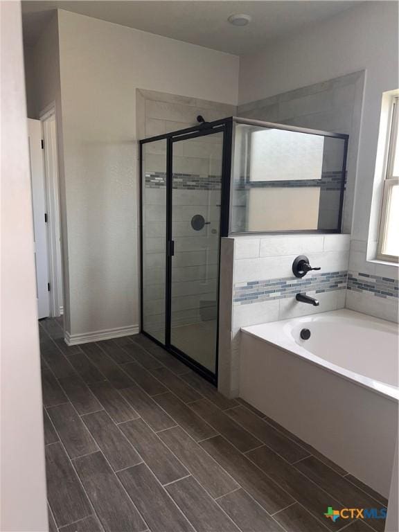 806 Dred Roger Cir, Killeen, TX 76542 - full bath featuring a bath, a shower stall, and wood tiled floors