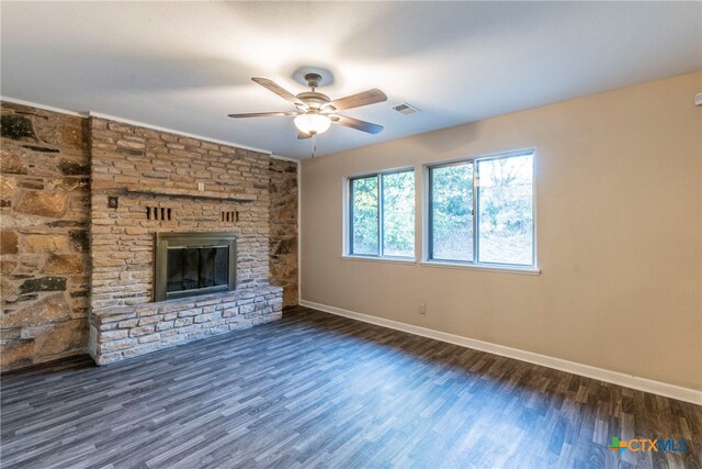 unfurnished living room with a stone fireplace, ceiling fan, and dark hardwood / wood-style floors