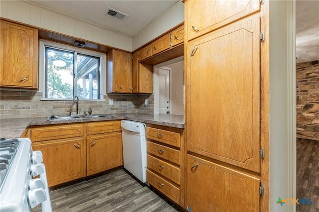 kitchen featuring white appliances, dark hardwood / wood-style floors, sink, and decorative backsplash