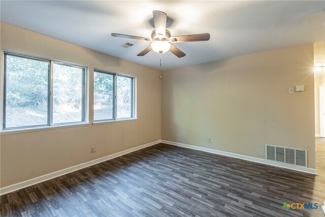 unfurnished room with dark wood-type flooring and ceiling fan