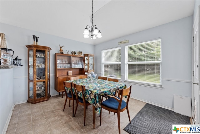 dining area with an inviting chandelier