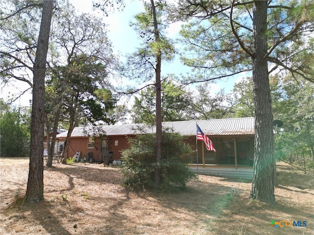 back of house featuring a sunroom