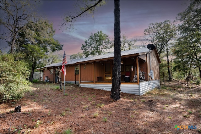 view of back house at dusk