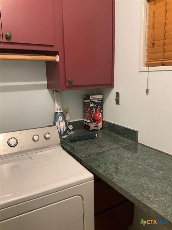 laundry room with cabinets and washer / dryer