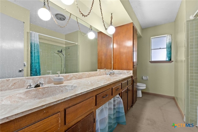 405 Carothers St, Copperas Cove, TX 76522 - bathroom featuring tiled shower, double vanity, and concrete flooring