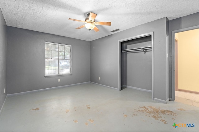 405 Carothers St, Copperas Cove, TX 76522 - unfurnished bedroom with concrete floors, a closet, a textured ceiling, and a ceiling fan