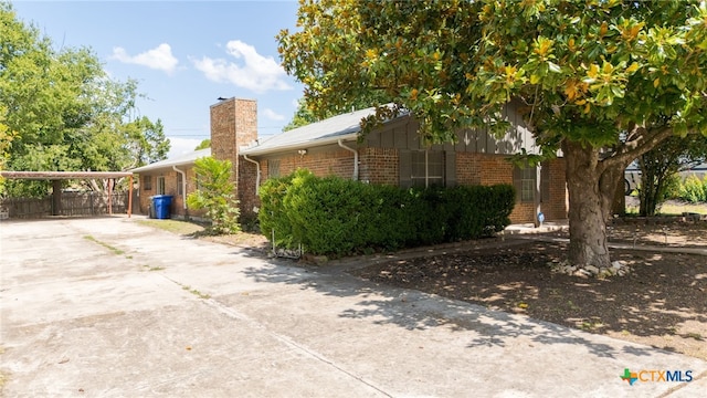405 Carothers St, Copperas Cove, TX 76522 - view of property exterior featuring brick siding, driveway, and a chimney