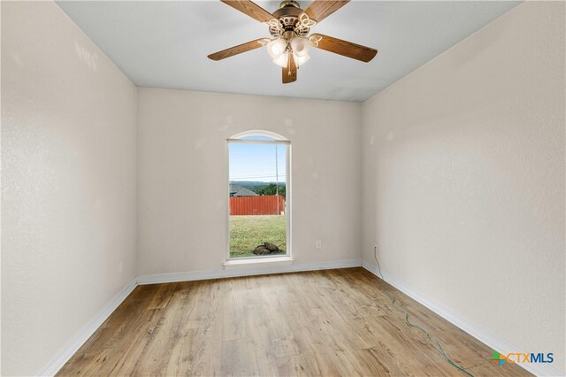 spare room with ceiling fan and light hardwood / wood-style floors