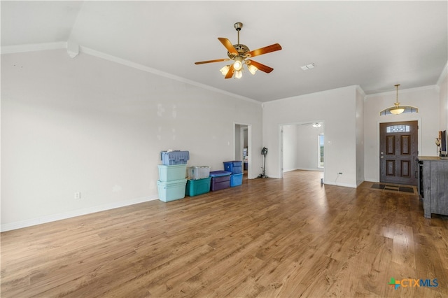 unfurnished living room with hardwood / wood-style floors, ceiling fan, crown molding, and lofted ceiling with beams