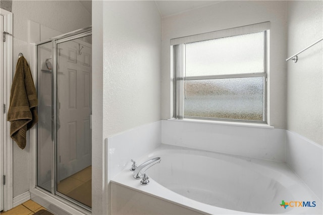 bathroom featuring independent shower and bath and tile patterned floors