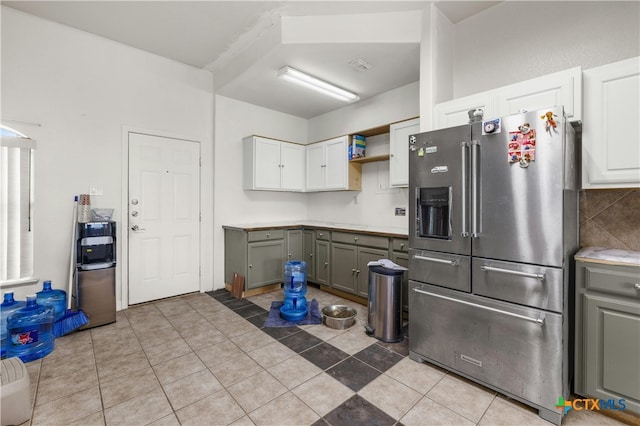 kitchen with gray cabinets, stainless steel refrigerator with ice dispenser, and white cabinets