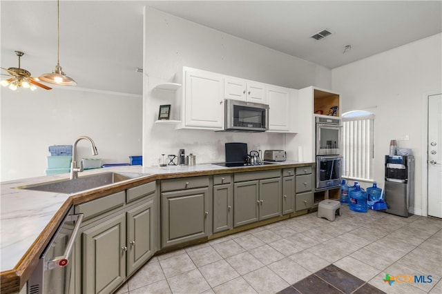 kitchen featuring gray cabinetry, light tile patterned flooring, stainless steel appliances, sink, and white cabinets