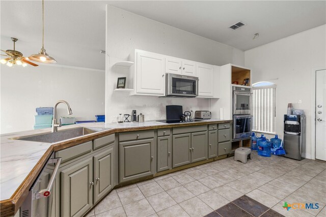 kitchen with gray cabinets, appliances with stainless steel finishes, white cabinetry, sink, and ceiling fan