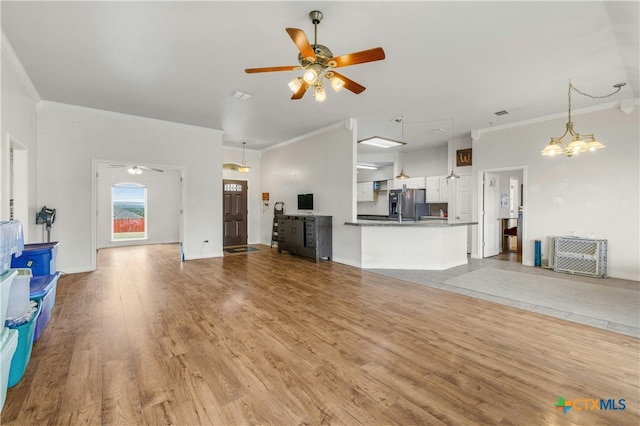 unfurnished living room with light wood-type flooring, ceiling fan with notable chandelier, and crown molding