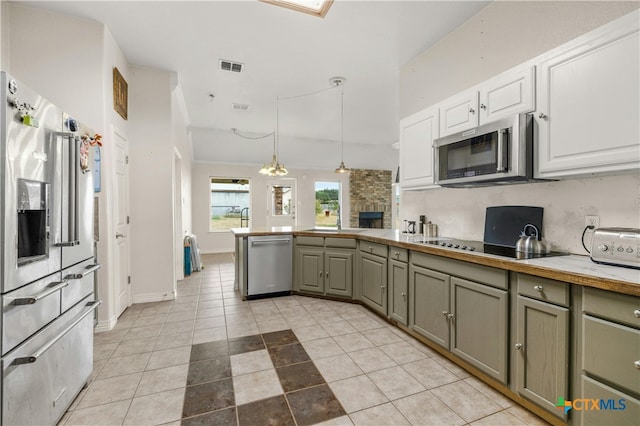 kitchen with gray cabinetry, hanging light fixtures, light tile patterned floors, appliances with stainless steel finishes, and white cabinets