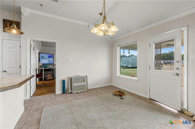 unfurnished dining area with light tile patterned flooring, crown molding, and a notable chandelier