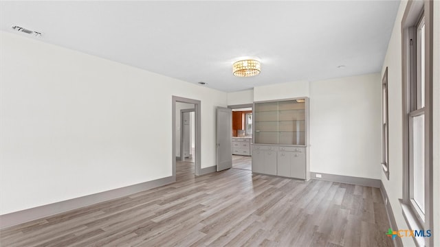 unfurnished room with light wood-type flooring