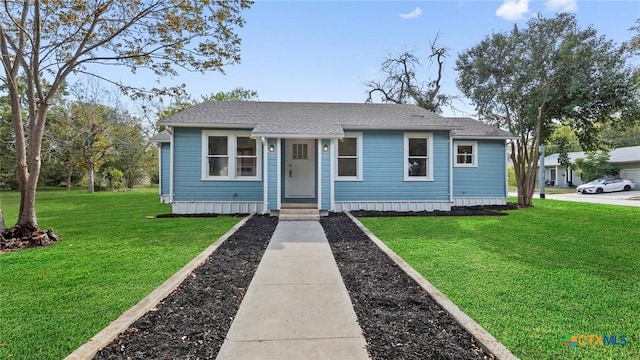 603 E Cedar St, Seguin, TX 78155 - view of front facade with a front lawn, a shingled roof, and entry steps