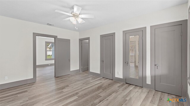 unfurnished bedroom with ceiling fan and light wood-type flooring