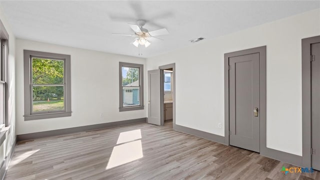 603 E Cedar St, Seguin, TX 78155 - unfurnished bedroom with light wood finished floors and ceiling fan