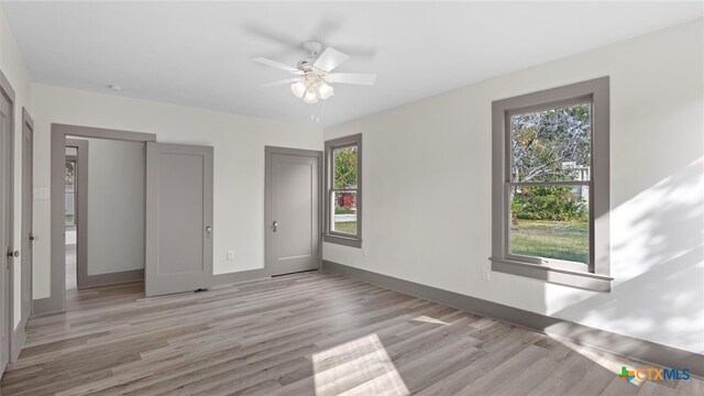 unfurnished bedroom featuring ceiling fan and light wood-type flooring