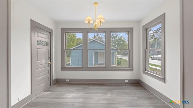 603 E Cedar St, Seguin, TX 78155 - unfurnished dining area featuring a chandelier and light wood finished floors