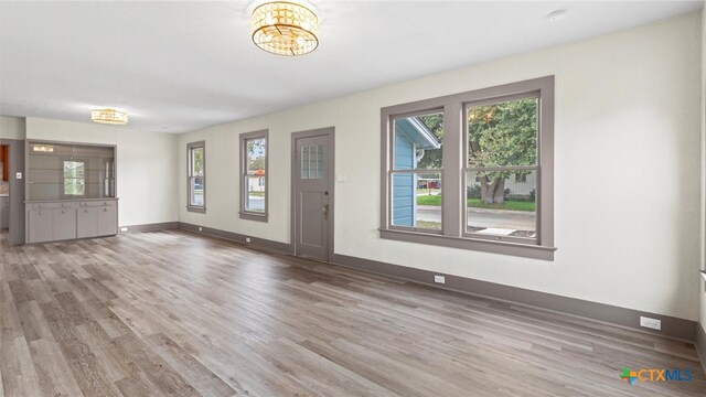 entryway featuring a chandelier, hardwood / wood-style flooring, and plenty of natural light