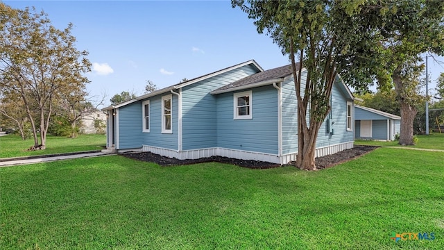 view of side of home with a lawn