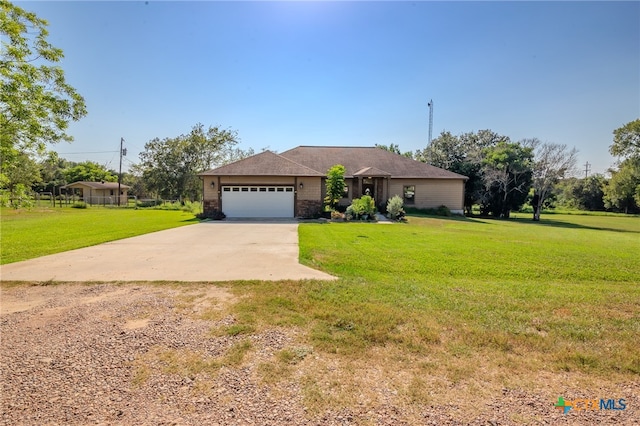 ranch-style home featuring a garage and a front lawn