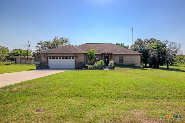 ranch-style home featuring a garage and a front lawn