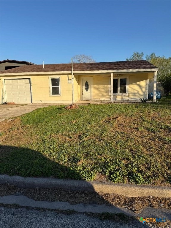 single story home featuring concrete driveway, a garage, and a front yard