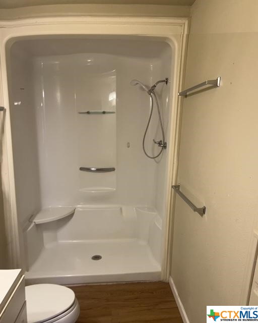 full bath with vanity, toilet, and a shower