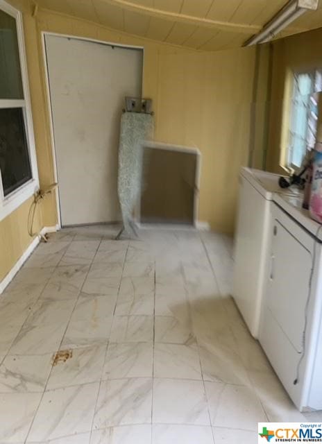 laundry room with laundry area and marble finish floor