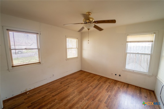 unfurnished room featuring ceiling fan, plenty of natural light, and hardwood / wood-style floors