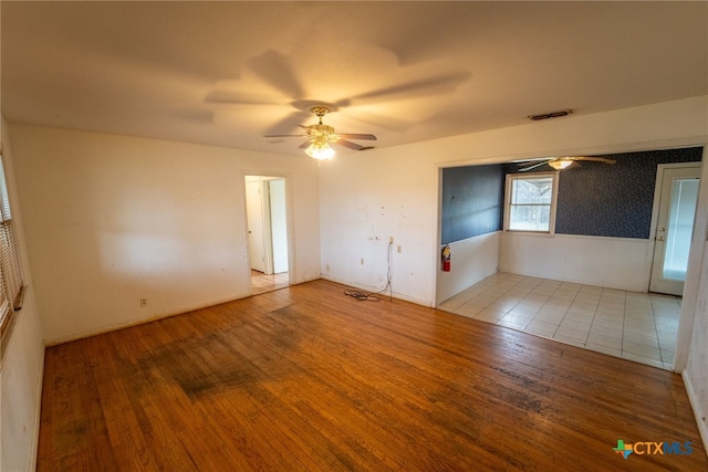 unfurnished room featuring ceiling fan and light wood-type flooring