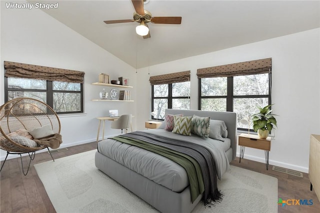 bedroom with hardwood / wood-style flooring, ceiling fan, and vaulted ceiling