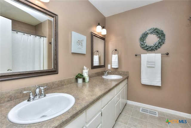 bathroom with vanity and tile patterned flooring