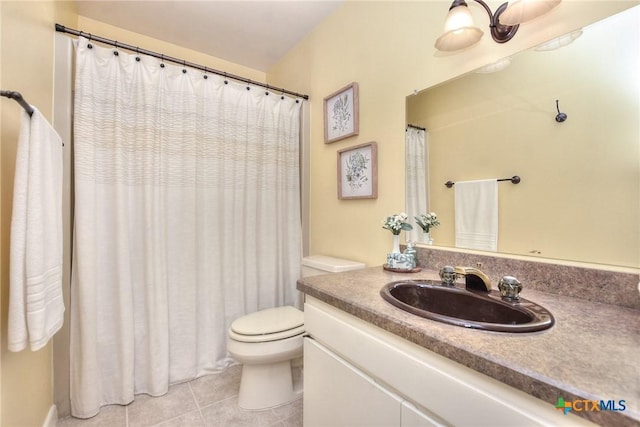 bathroom with tile patterned flooring, vanity, and toilet