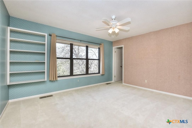 unfurnished room featuring carpet and ceiling fan