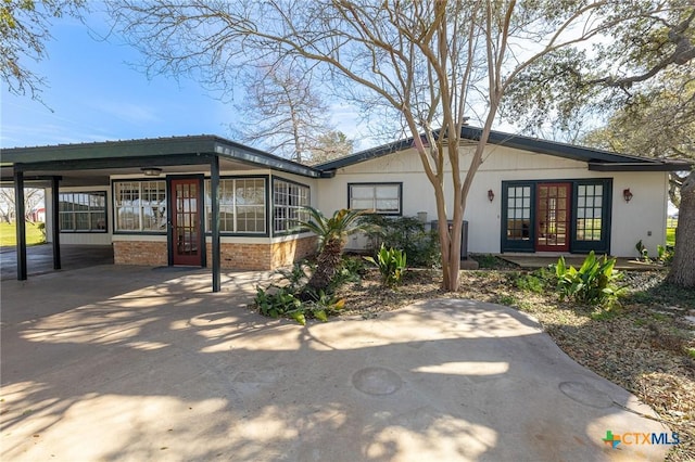 view of front of property featuring french doors and driveway