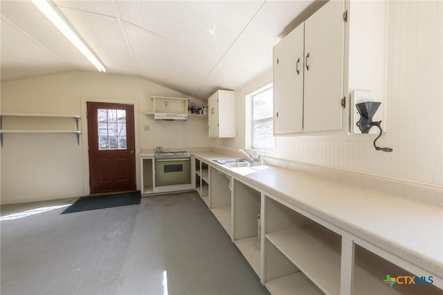 kitchen with open shelves, light countertops, a sink, and gas range