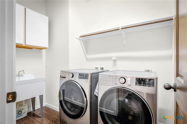 2051 Western Pecan, New Braunfels, TX 78130 - clothes washing area with dark wood-style floors, cabinet space, independent washer and dryer, and baseboards