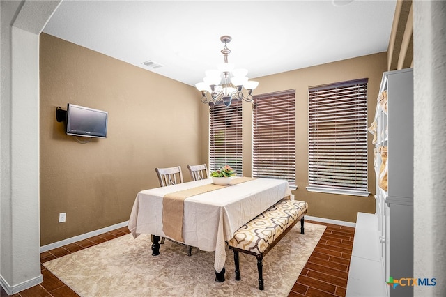 2051 Western Pecan, New Braunfels, TX 78130 - dining room with visible vents, arched walkways, an inviting chandelier, baseboards, and wood finish floors
