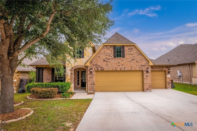 2051 Western Pecan, New Braunfels, TX 78130 - view of front of property featuring a garage, brick siding, a front lawn, and driveway