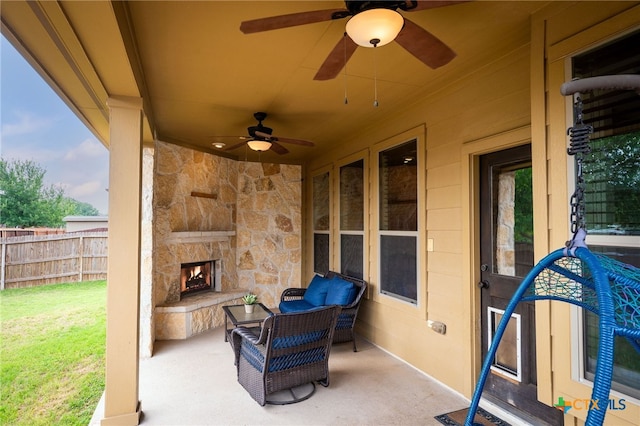 2051 Western Pecan, New Braunfels, TX 78130 - view of patio featuring fence, ceiling fan, and an outdoor stone fireplace