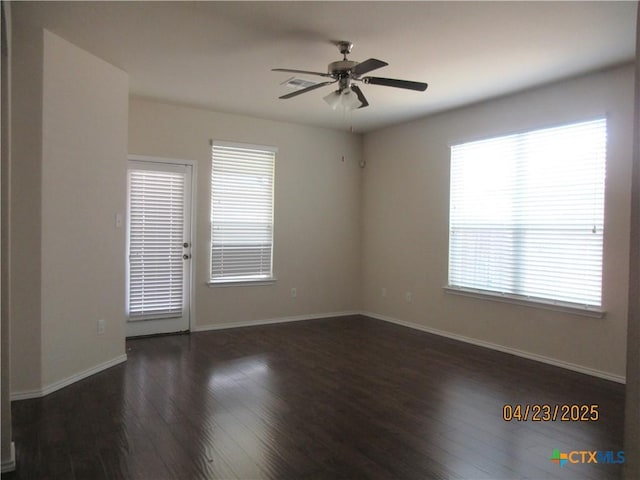 empty room featuring baseboards, wood finished floors, and ceiling fan