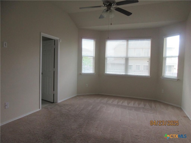 unfurnished room featuring carpet, plenty of natural light, a ceiling fan, and baseboards