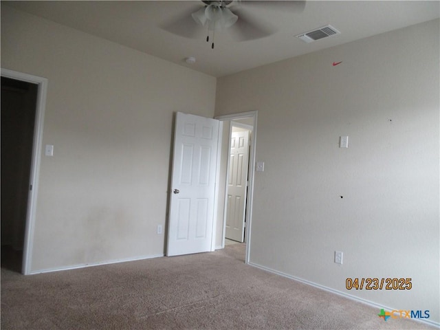 interior space with a ceiling fan, visible vents, and baseboards