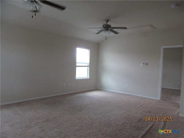 spare room with attic access, ceiling fan, light carpet, and baseboards